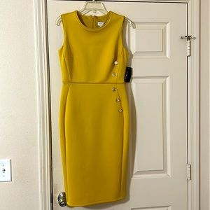 Mustard colored dress with gold buttons on the side